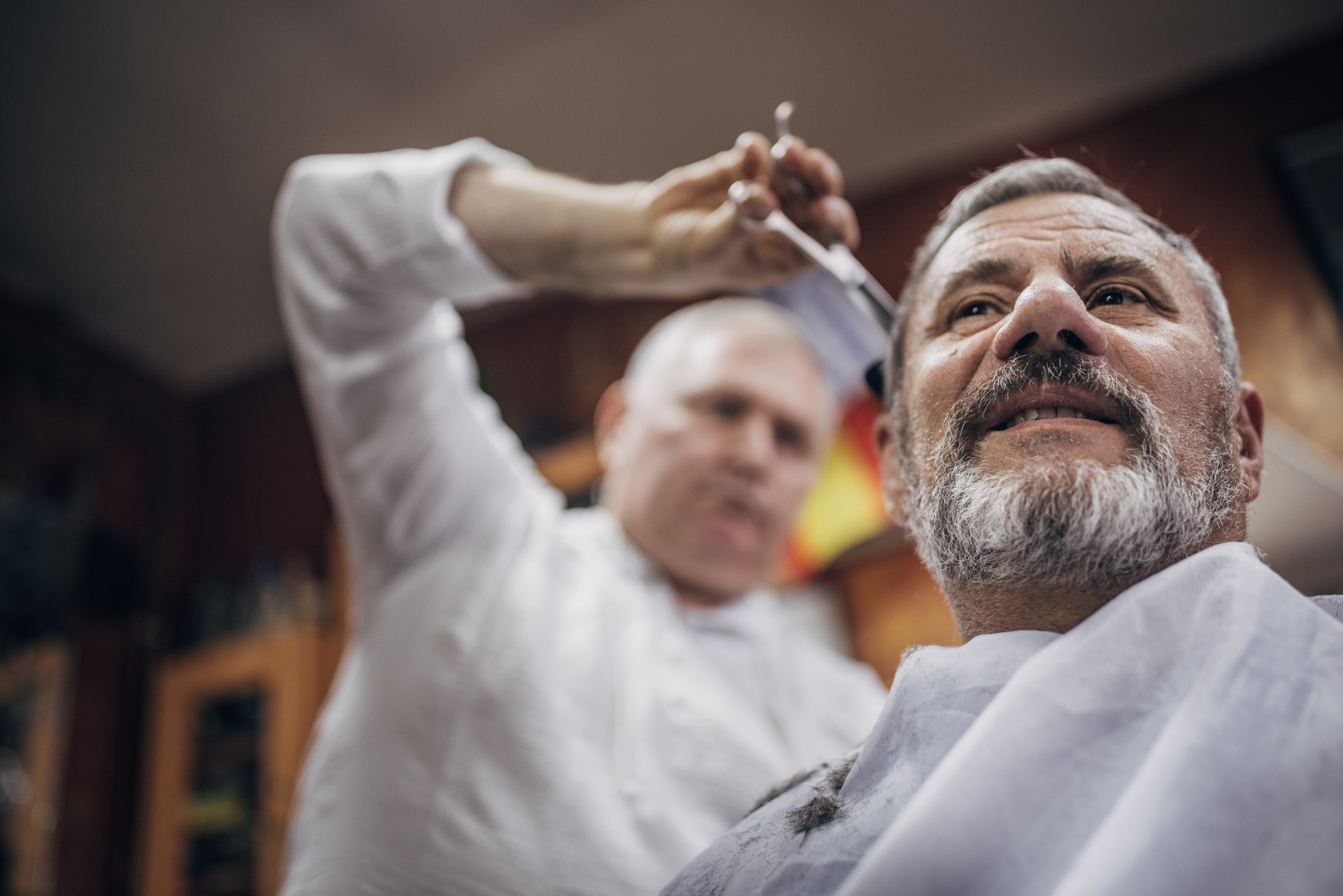 Haircut, the hairdresser uses a comb and scissors